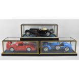 Three Cased Diecast Models, Ferrari, Vintage Sports Car and Racing Car, Each case 29cms Wide