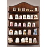 A Collection of Various Souvenir Thimbles including One Silver Example Together with Wooden Wall