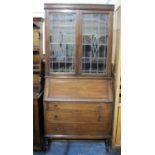 An Edwardian Oak Bureau Bookcase with Fall Front to Fitted Interior, Three Drawers and Barley