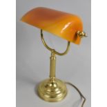 A Reproduction Brass Desktop Reading Light with Opaque Amber Shade