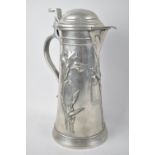 An Art Nouveau Lidded Pewter Jug Decorated in Relief with Irises, 26cm high
