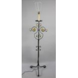 A Wrought Iron Standard Lamp with Tripod Support