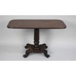 A Mid 19th Century Mahogany Rectangular Table Having Reeded Column Support, Quadrant Base with