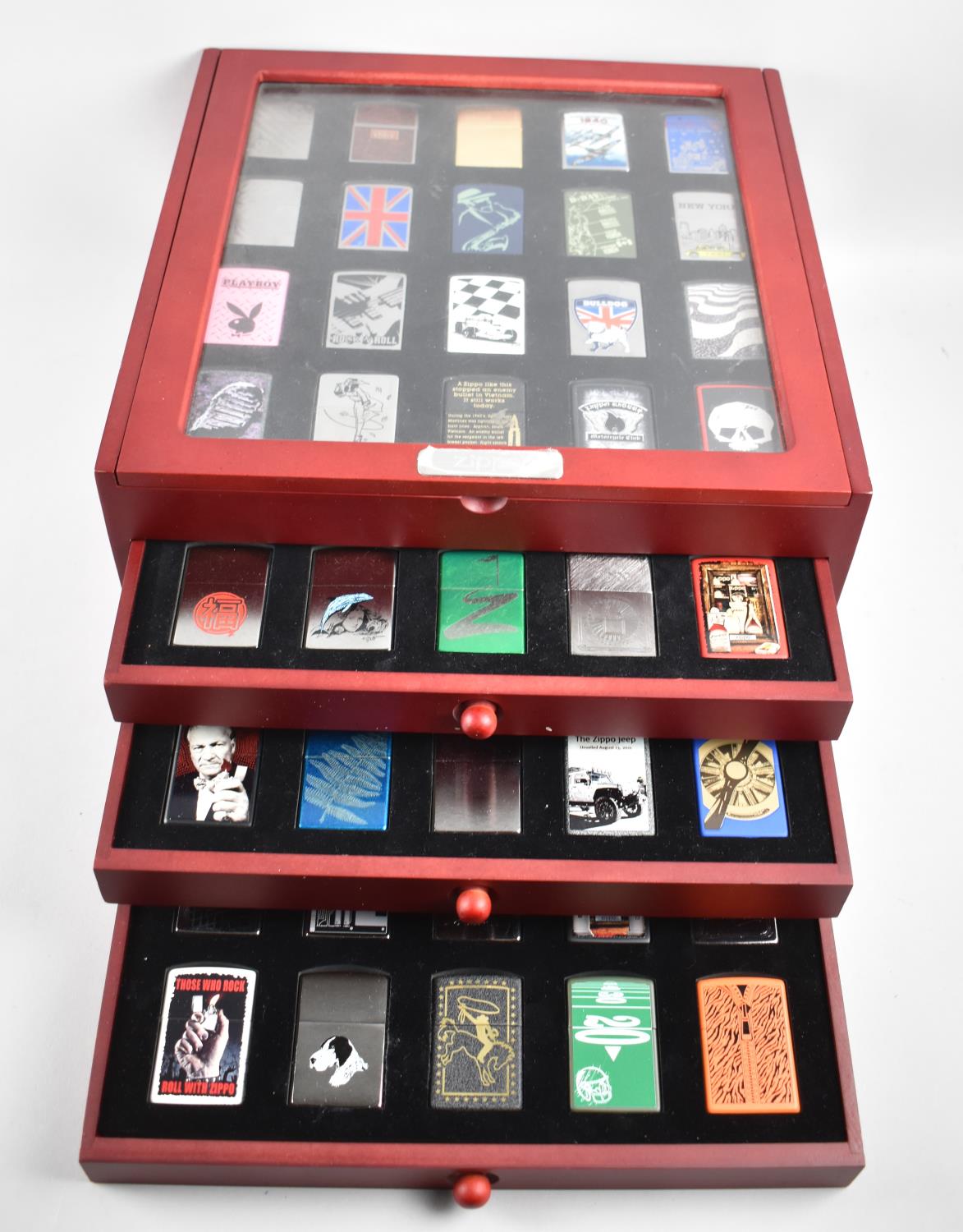 A Complete Set of Eighty DeAgostini Zippo Lighters in Four Section Display Case, 32cm wide,
