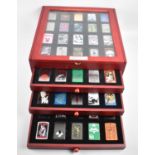 A Complete Set of Eighty DeAgostini Zippo Lighters in Four Section Display Case, 32cm wide,