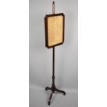 A Victorian Mahogany Pole Screen with Silk Embroidered Rise and Fall Panel on Tripod Support