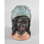 A Continental Cold Painted Bisque Tobacco Pot in the Form of a Maiden's Head, 16.5cms High