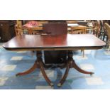 A Mahogany Twin Pedestal Twin Dining Table with One Extra Leaf