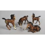 A Collection of Four Beswick Foals, Recumbent Example with Ear Chipped