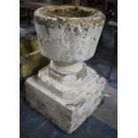 A Reconstituted Stone Cream Painted and Weathered Garden Planter of Urn Form on Square Tiered