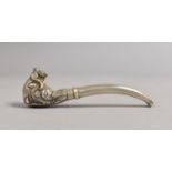 A White Metal Oriental Pipe with Dragon Mask Decorated Bowl, 10cms Long