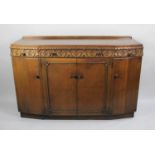 A Mid 20th Century Bow fronted Oak Sideboard with Three Top Drawers over Cupboard, Galleried Back,