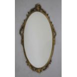 A Mid 20th Century Gilt Metal Oval Wall mirror, 67x38cms