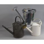 A Collection of Three Metal watering Cans