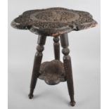 A Scallop Edged Two Tier Carved Indian Table on Turned Tripod Supports, 38cms Diameter