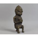 A Cast Benin Bronze Figure, Seated Tribal Gent with Bowl, 20cm high