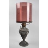 A Late Victorian Cast Metal Oil Lamp with Aubergine Glass Storm Shade, Moulded Decoration to Base,