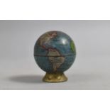 A Novelty Tin Plate Pencil Sharpener in the Form of a Globe, 4.5cms High