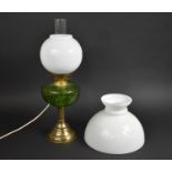An Electric Converted Oil Lamp Having Domed Brass and Reeded Column Supporting Green Glass Reservoir