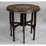 An Indian Folding Table with Circular Top Having Profusely Carved Design Incorporating Elephants,
