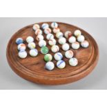 A Far Eastern Wooden Circular Solitaire Board with Store Under and Set of Marbles, 20cms Diameter