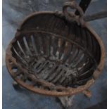 A Cast Iron Fire Basket of Oval Form decorated with Scrolled Design on Quadrant Scrolled Pad Feet,