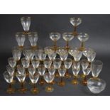 A Set of Amber Stemmed and Gilt Trimmed Drinking Glasses to include Cups, Sherries, Wines Etc