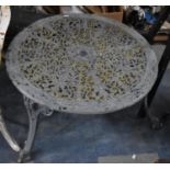 A Cast Metal Cylindrical Patio Coffee Table with Pierced Top Supported on Tripod Legs of Scrolled