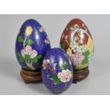 Three Cloisonne Eggs, Two with Wooden Stands