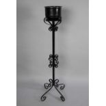 A Wrought Iron Plant Stand with Scrolled Design and Quadrant Base, 116cms High