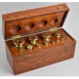 A Cased Set of Brass Troy Ounce Weights, Stamped GR, 28cms Wide
