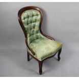 A Reproduction Button Upholstered Serpentine Front Balloon Back Nursing Chair