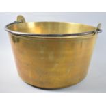 A Large Heavy Brass Circular Jam Kettle with Steel Loop Handle, 35cms Diameter