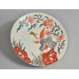 A Japanese Porcelain Plate Decorated in the Imari Palette with Phoenix Amongst Blossoming Flowers