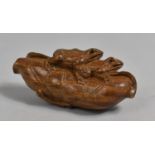 A Carved Wooden Okimono in the form of Two Frogs on a Rolled Lilypad, Signed, 8cm Long