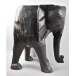 A Large Carved Wooden Stool in the Form of an Elephant, 45cms High