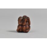 A Carved Wooden Netsuke in the form of Three Monkeys, "Hear No Evil, See No Evil, Speak No Evil",