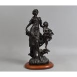 A Bronze Effect Resin Figure Group depicting Maiden with Bunch of Grapes Beside Cherub with Ewer,