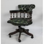 A 20th Century Victorian Style Green Leather Button Back Swivel Office Chair having Spindle Back
