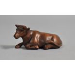 A Carved Wooden Netsuke in the form of a Recumbent Cow, Signed, 5cm Long