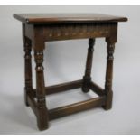 A Mid 20th Century Oak Rectangular Topped Stool with Turned Supports, 48cms Long