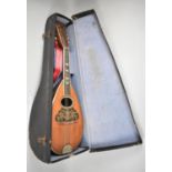 A Cased Italian Eight String Mandolin with Inlaid Tortoiseshell and Mother of Pearl