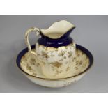 A Mintons Toilet Bowl and Jug with Floral Transfer Printed Design Enriched with Gilt on Cream Ground