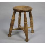 A Vintage Pine Circular Topped Stool on Four Turned Supports, 26cms Diameter