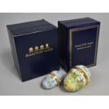 Two Boxed Enamelled Halcyon Days Boxes in the The form of Eggs