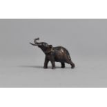 A Small Bronze Study of a Bull Elephant with Trunk in Salute, 4.5cms Long