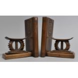 A Pair of Carved Wooden Bookends in the Form of African Headrests, 16cms High