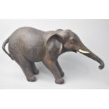 A Ceramic Model of an Elephant Pulling Backwards, 35cms Long