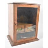 An Edwardian Oak Glazed Smokers Cabinet with Two Inner Drawers, 28cms Wide