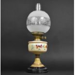 An Edwardian Oil Lamp with Brass Base on Circular Plinth Opaque Glass Reservoir, Decorated with